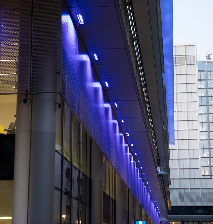 Modern building with blue illuminated lights.