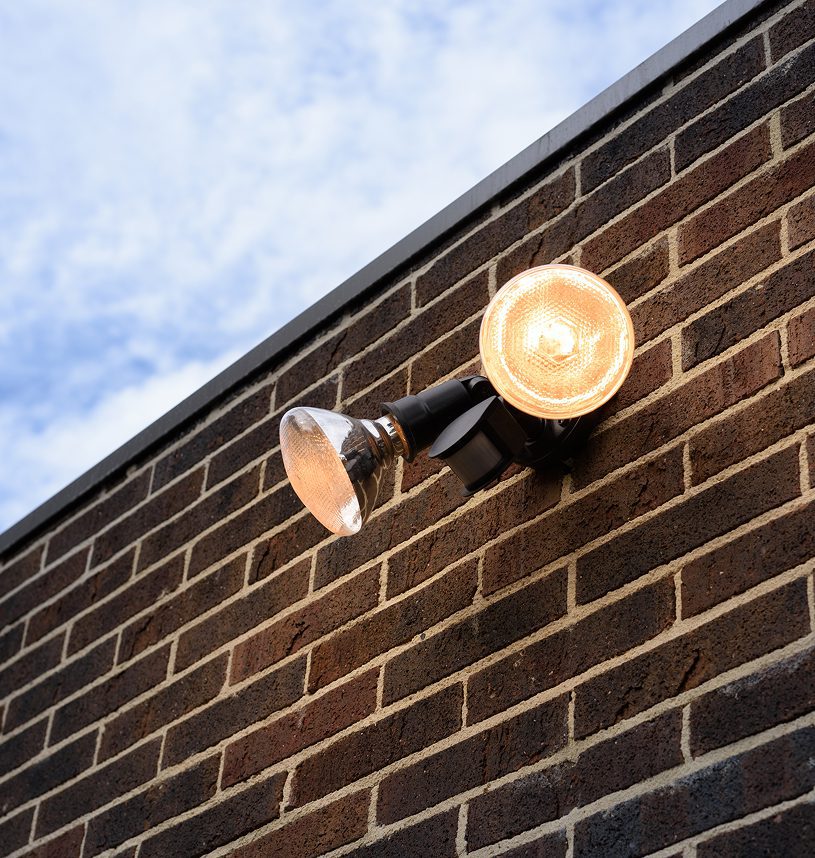 Outdoor light fixture on brick wall.