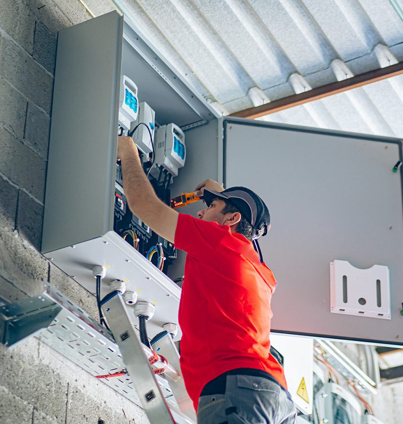 Electrician working on an electrical panel installation.